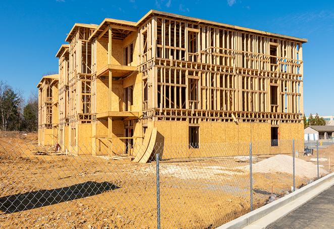 a temporary chain link fence winding around a construction site, outlining the project's progress in Anaheim CA